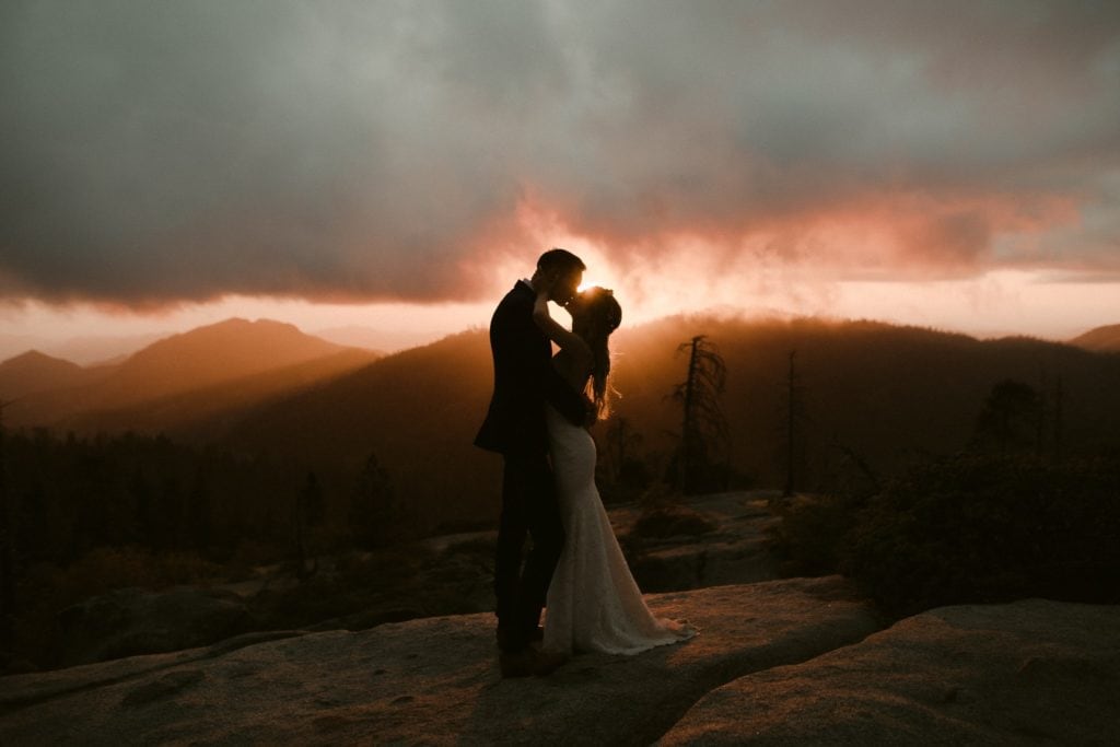 Bride and Groom kiss over amazing sunset in the Sequoia National Park